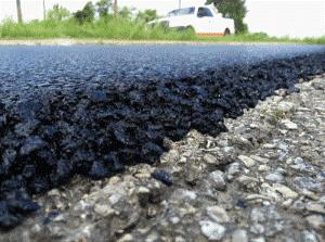 Blacktop overlay in progress in Northern Virginia — a fresh layer of asphalt placed directly over the existing roadway surface