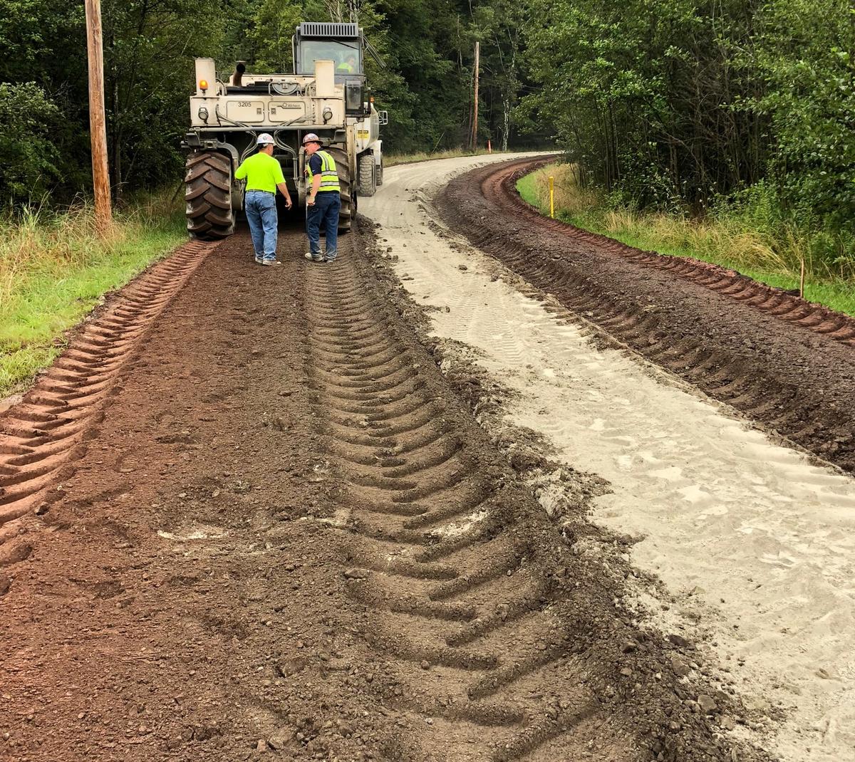 Pavement reclamation project on a private road in Northern Virginia — crew inspecting the freshly reclaimed base before repaving